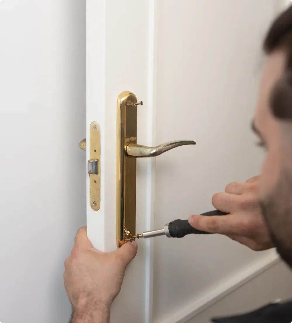 Profesional cambiando manilla de puerta con destornillador